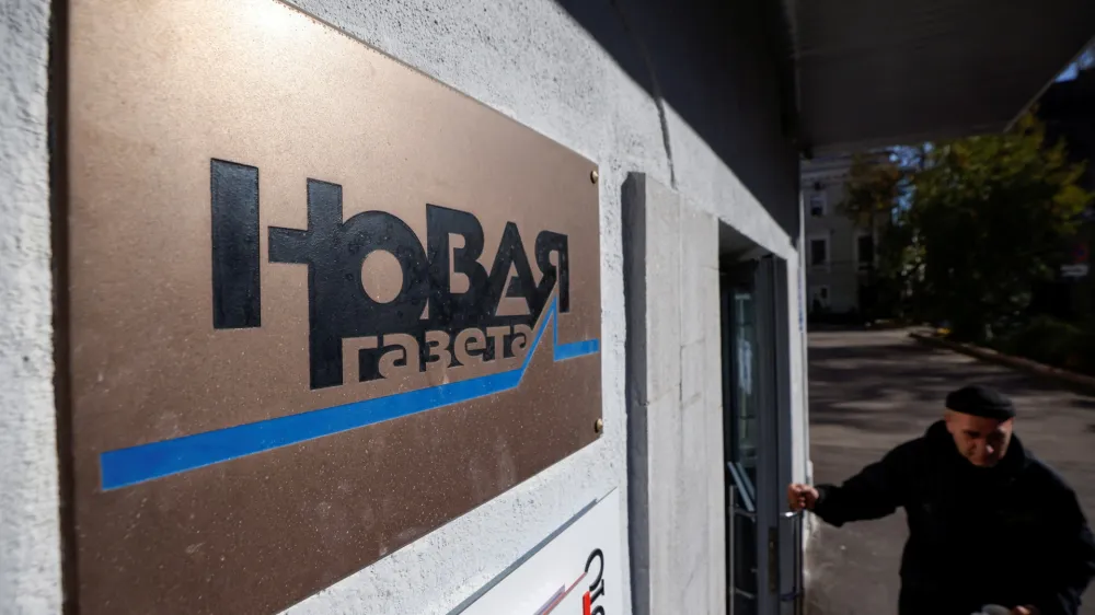 FILE PHOTO: Russian investigative newspaper Novaya Gazeta's plate is seen next to an entrance to the office in Moscow October 8, 2021. REUTERS/Maxim Shemetov/File Photo