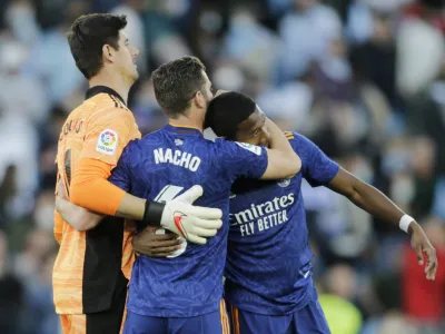 Soccer Football - LaLiga - Celta Vigo v Real Madrid - Estadio de Balaidos, Vigo, Spain - April 2, 2022 Real Madrid's Thibaut Courtois, Nacho, and David Alaba celebrate after the match REUTERS/Miguel Vidal