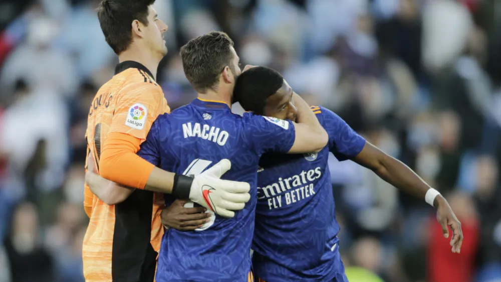 Soccer Football - LaLiga - Celta Vigo v Real Madrid - Estadio de Balaidos, Vigo, Spain - April 2, 2022 Real Madrid's Thibaut Courtois, Nacho, and David Alaba celebrate after the match REUTERS/Miguel Vidal
