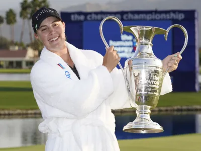 Jennifer Kupcho hold the winner's trophy on the 18th hole after winning the LPGA Chevron Championship golf tournament Sunday, April 3, 2022, in Rancho Mirage, Calif. (AP Photo/Marcio Jose Sanchez)