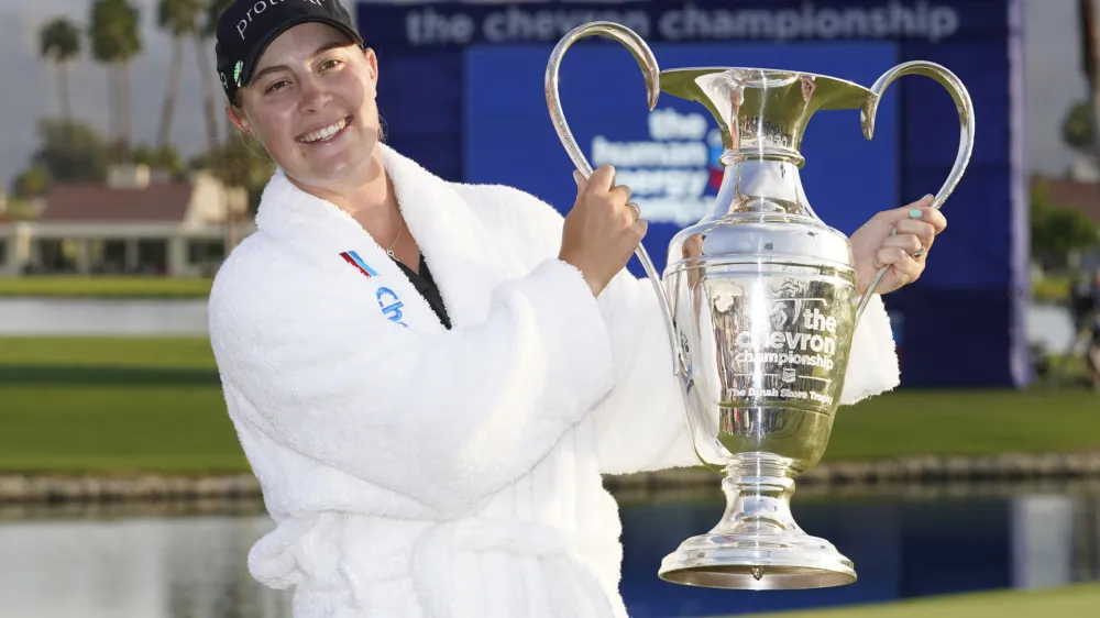 Jennifer Kupcho hold the winner's trophy on the 18th hole after winning the LPGA Chevron Championship golf tournament Sunday, April 3, 2022, in Rancho Mirage, Calif. (AP Photo/Marcio Jose Sanchez)