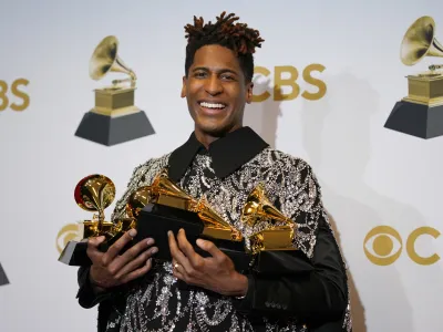 Jon Batiste, winner of the awards for best American roots performance for "Cry," best American roots song for "Cry," best music video for "Freedom," best score soundtrack for visual media for "Soul," and album of the year for "We Are," poses in the press room at the 64th Annual Grammy Awards at the MGM Grand Garden Arena on Sunday, April 3, 2022, in Las Vegas. (AP Photo/John Locher)