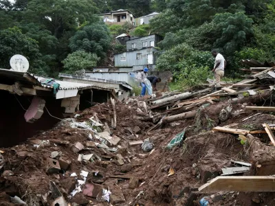 Men sift through the rubble of a church which collapsed onto a house killing four children in Clermont, Durban, South Africa, April 13, 2022. REUTERS/Rogan Ward