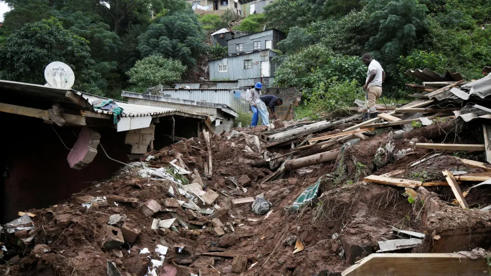 Men sift through the rubble of a church which collapsed onto a house killing four children in Clermont, Durban, South Africa, April 13, 2022. REUTERS/Rogan Ward