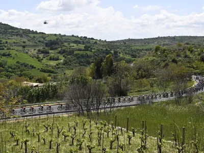 Cyclists make their way through the countryside during the fourth stage of the Giro D'Italia cycling race from Avola to Etna-Nicolosi, Italy, Tuesday, May 10, 2022. (Fabio Ferrari/LaPresse via AP)