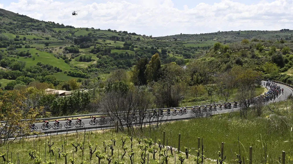 Cyclists make their way through the countryside during the fourth stage of the Giro D'Italia cycling race from Avola to Etna-Nicolosi, Italy, Tuesday, May 10, 2022. (Fabio Ferrari/LaPresse via AP)