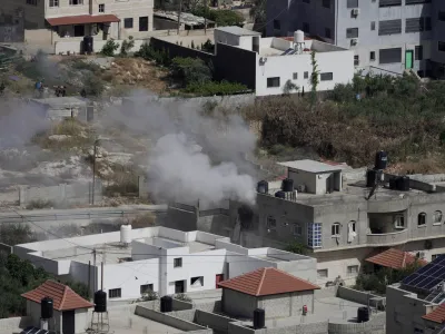 CORRECTS CIRCUMSTANCES - Smoke rises from a home during an Israeli military operation in the West Bank town of Jenin, Friday, May 13, 2022. Israeli troops pushed into Jenin early Friday two days after veteran Al Jazeera correspondent Shireen Abu Akleh was killed while covering a military operation in the occupied West Bank. (AP Photo/Majdi Mohammed)