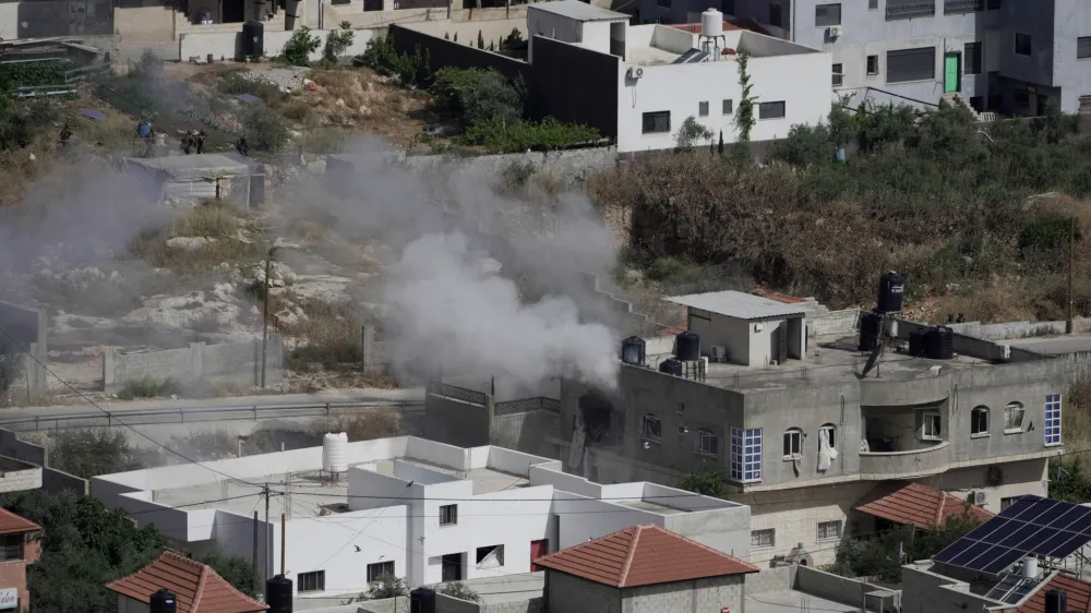 CORRECTS CIRCUMSTANCES - Smoke rises from a home during an Israeli military operation in the West Bank town of Jenin, Friday, May 13, 2022. Israeli troops pushed into Jenin early Friday two days after veteran Al Jazeera correspondent Shireen Abu Akleh was killed while covering a military operation in the occupied West Bank. (AP Photo/Majdi Mohammed)