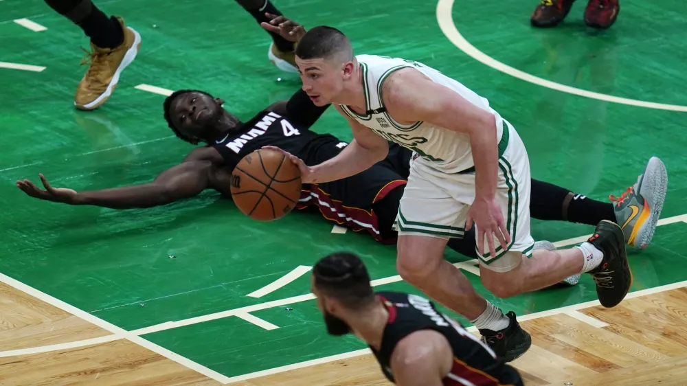 Miami Heat guard Victor Oladipo (4) looks toward officials for a call as Boston Celtics guard Payton Pritchard heads downcourt during the second half of Game 4 of the NBA basketball playoffs Eastern Conference finals, Monday, May 23, 2022, in Boston. (AP Photo/Charles Krupa)