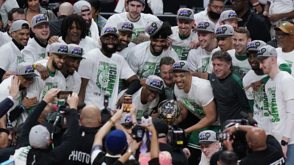 The Boston Celtics pose with the NBA Eastern Conference trophy after defeating the Miami Heat in Game 7 of the NBA basketball Eastern Conference finals playoff series, Sunday, May 29, 2022, in Miami. (AP Photo/Wilfredo Lee)