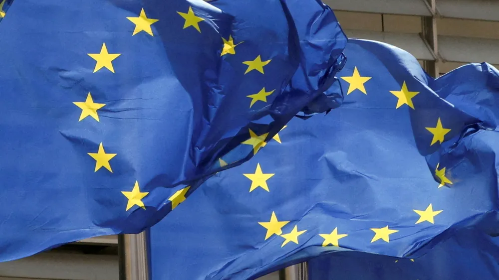 FILE PHOTO: European Union flags flutter outside the EU Commission headquarters in Brussels, Belgium May 5, 2021. REUTERS/Yves Herman/File Photo