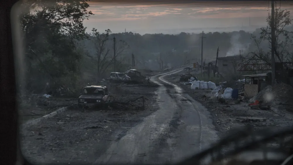 The gutted remains of cars lie along a road during heavy fighting at the front line in Severodonetsk, Luhansk region, Ukraine, Wednesday, June 8, 2022. (AP Photo/Oleksandr Ratushniak)