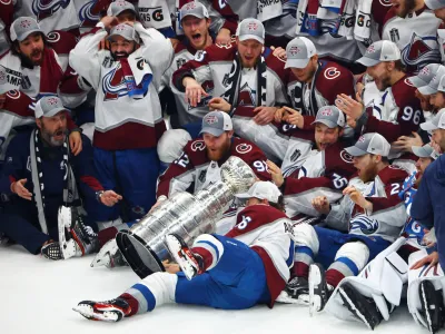 Jun 26, 2022; Tampa, Florida, USA; The Colorado Avalanche players react as right wing Nicolas Aube-Kubel (16) falls and drops the Stanley Cup trophy on the ice after defeating the Tampa Bay Lightning to win the Stanley Cup in game six of the 2022 Stanley Cup Final at Amalie Arena. Mandatory Credit: Mark J. Rebilas-USA TODAY Sports