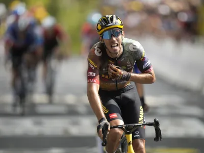 France's Christophe Laporte celebrates as he crosses the finish line to win the nineteenth stage of the Tour de France cycling race over 188.5 kilometers (117.3 miles) with start in Castelnau-Magnoac and finish in Cahors, France, Friday, July 22, 2022. (AP Photo/Daniel Cole)