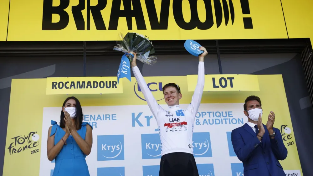 Cycling - Tour de France - Stage 20 - Lacapelle-Marival to Rocamadour - France - July 23, 2022 UAE Team Emirates' Tadej Pogacar celebrates on the podium wearing the white jersey after stage 20 REUTERS/Gonzalo Fuentes