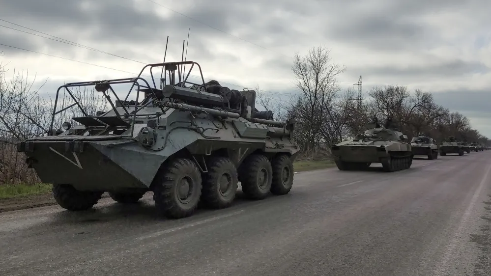 FILE - A Russian military convoy moves on a highway in an area controlled by Russian-backed separatist forces near Mariupol, Ukraine, on April 16, 2022. As the war in Ukraine stretches into its seventh month, North Korea is hinting at its interest in sending construction workers to help rebuild Russian-occupied territories in the country's east.(AP Photo/Alexei Alexandrov, File)