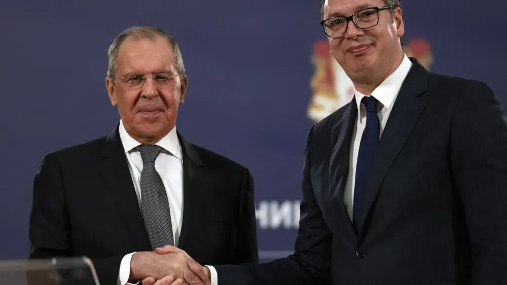 FILE - Russian Foreign Minister Sergey Lavrov, left, shakes hands with Serbia's President Aleksandar Vucic after a press conference in Belgrade, Serbia, Sunday, Oct. 10, 2021. European Union candidate Serbia has signed an agreement with Russia to hold mutual "consultations" on foreign policy matters. Serbian Foreign Affairs Minister Nikola Selakovic signed the agreement with Russian Foreign Minister Sergey Lavrov on the margins of the U.N. General Assembly. (AP Photo/Darko Vojinovic, File)