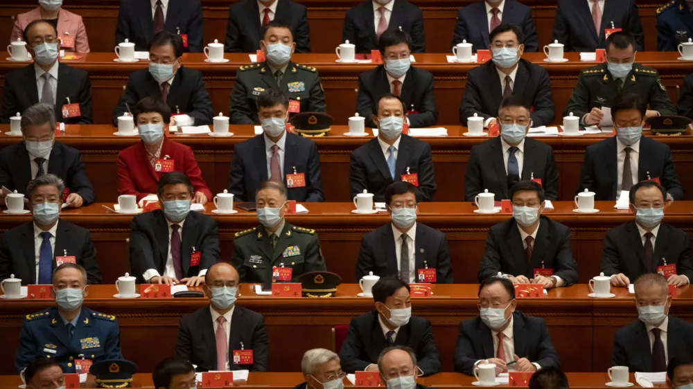 Delegates wearing face masks sit before the opening session of the 20th National Congress of China's ruling Communist Party in Beijing, China, Sunday, Oct. 16, 2022. As China's ruling Communist Party holds a major congress this week, many Beijing residents are wondering if the end of the meeting will bring any easing of China's draconian "zero-COVID" policies that are disrupting lives and the economy. (AP Photo/Mark Schiefelbein)