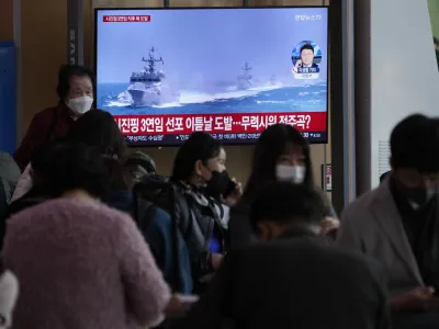 A TV screen shows a file image of South Korean navy vessels during a news program at the Seoul Railway Station in Seoul, South Korea, Monday, Oct. 24, 2022. The rival Koreas exchanged warning shots along their disputed western sea boundary on Monday, their militaries said, amid heightened animosities over North Korea's recent barrage of weapons tests. (AP Photo/Ahn Young-joon)