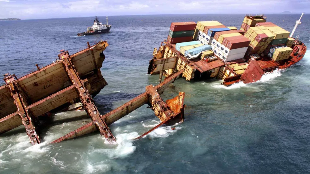 Debris floats around the remains of the stricken container ship Rena as it submerges, about 14 nautical miles (22 km) from Tauranga, on the east coast of New Zealand's North Island January 10, 2012. The stern section of the stricken cargo ship is slipping off a New Zealand reef where it has been stuck for three months and is in danger of sinking, authorities said, complicating salvage efforts in one of the nation's worst environmental disasters. REUTERS/Maritime New Zealand/Handout (NEW ZEALAND - Tags: DISASTER ENVIRONMENT) FOR EDITORIAL USE ONLY. NOT FOR SALE FOR MARKETING OR ADVERTISING CAMPAIGNS. THIS IMAGE HAS BEEN SUPPLIED BY A THIRD PARTY. IT IS DISTRIBUTED, EXACTLY AS RECEIVED BY REUTERS, AS A SERVICE TO CLIENTS