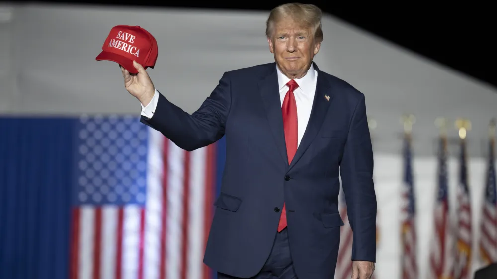 FILE - Former President Donald Trump makes his entrance at a rally at the Minden Tahoe Airport in Minden, Nev., Oct. 8, 2022. (AP Photo/Jos&eacute; Luis Villegas, File)