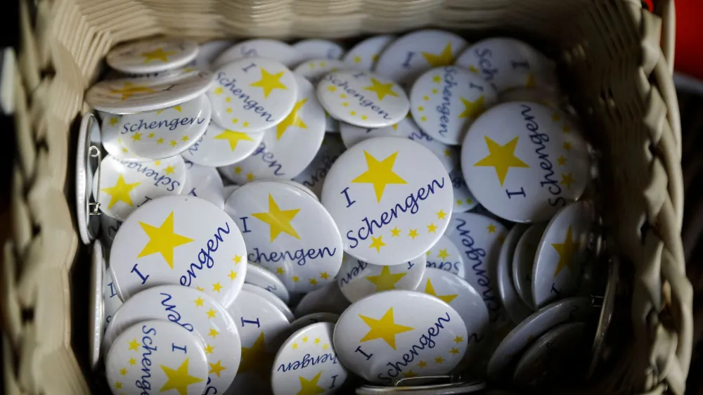 FILE PHOTO: Badges with text 'I Love Schengen' are pictured at a store of the European museum of Schengen, Luxembourg January 27, 2016. REUTERS/Wolfgang Rattay/File Photo
