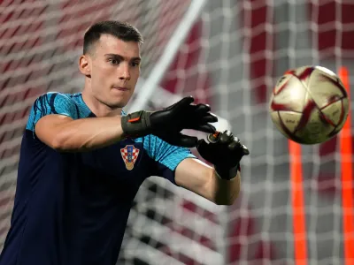 Croatia's goalkeeper Dominik Livakovic catches the ball during the training session on the eve of the 2022 World Cup semifinal soccer match between Croatia and Argentina in Doha, Monday, Dec. 12, 2022. (AP Photo/Petr David Josek)
