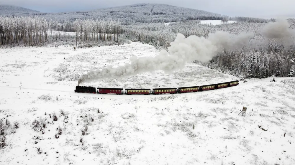 A steam train drives through a snow-covered landscape at the Harz mountains near Wernigerode, Germany, Friday, Dec. 9, 2022. (AP Photo/Matthias Schrader)