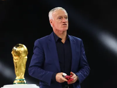 Soccer Football - FIFA World Cup Qatar 2022 - Final - Argentina v France - Lusail Stadium, Lusail, Qatar - December 18, 2022 France coach Didier Deschamps walks past the World Cup trophy after receiving the silver medal REUTERS/Carl Recine