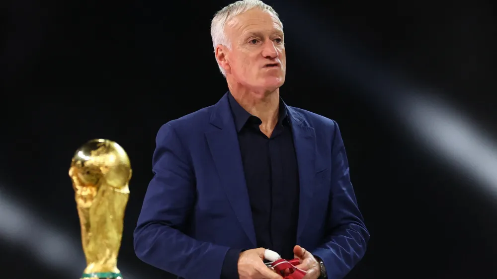 Soccer Football - FIFA World Cup Qatar 2022 - Final - Argentina v France - Lusail Stadium, Lusail, Qatar - December 18, 2022 France coach Didier Deschamps walks past the World Cup trophy after receiving the silver medal REUTERS/Carl Recine