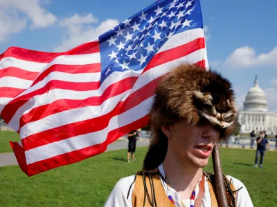 A man wearing a raccoon hat talks about his belief that U.S. former President Donald Trump won the election and that it was stolen from him through fraud, during a rally in support of defendants being prosecuted in the January 6 attack on the Capitol, in Washington, U.S., September 18, 2021. REUTERS/Jim Bourg   TPX IMAGES OF THE DAY - RC2ISP95J32I