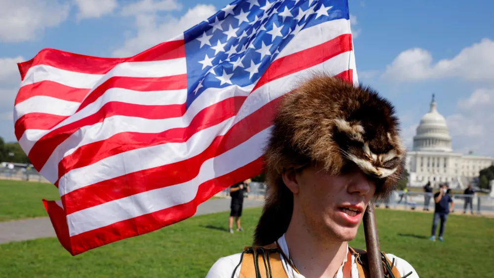 A man wearing a raccoon hat talks about his belief that U.S. former President Donald Trump won the election and that it was stolen from him through fraud, during a rally in support of defendants being prosecuted in the January 6 attack on the Capitol, in Washington, U.S., September 18, 2021. REUTERS/Jim Bourg   TPX IMAGES OF THE DAY - RC2ISP95J32I