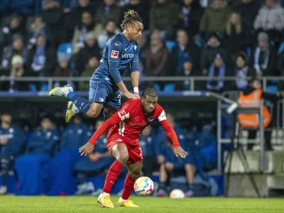 Bochum's Pierre Kunde, left, and Berlin's Jessic Ngankam challenge for the ball during the German Bundesliga soccer match between VfL Bochum and Hertha BSC Berlin in Bochum, Germany, Saturday, Jan. 21, 2023. (David Inderlied/dpa via AP)