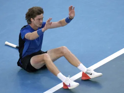 Andrey Rublev of Russia celebrates after defeating Holger Rune of Denmark in their fourth round match at the Australian Open tennis championship in Melbourne, Australia, Monday, Jan. 23, 2023. (AP Photo/Dita Alangkara)