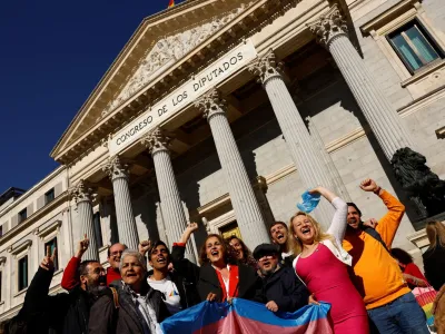 LGBT activists celebrate after the final approval of a law that will make it easier for people to self-identify as transgender, outside Spain's Parliament in Madrid, Spain, February 16, 2023. REUTERS/Susana Vera