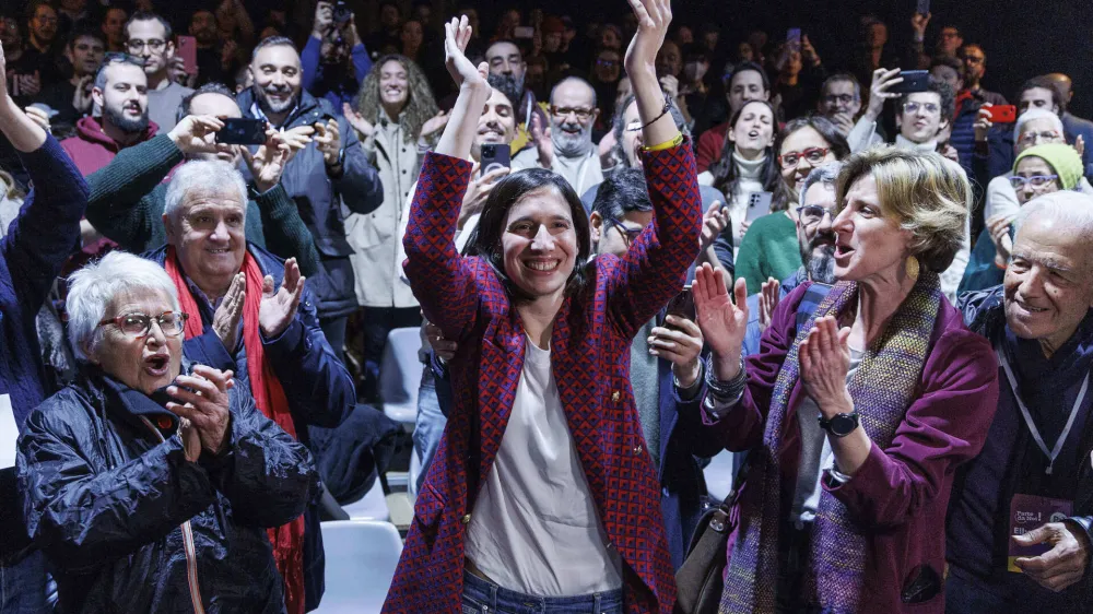 Elly Schlein, center, gestures at the headquarters of her electoral committee, after the announcement of the partial results of the Democratic Party primaries in Rome, Italy, Sunday, Feb. 26, 2023. Schlein, a 37-year-old U.S.-Italian national and longtime left-wing political operative, has defied polls to become the first woman to head Italy's opposition Democratic Party. (Roberto Monaldo/LaPresse via AP)