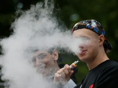 A man exhales electronic cigarette vapour in a park in central Kiev, Ukraine May 12, 2017. REUTERS/Valentyn Ogirenko - RC1445F0D830
