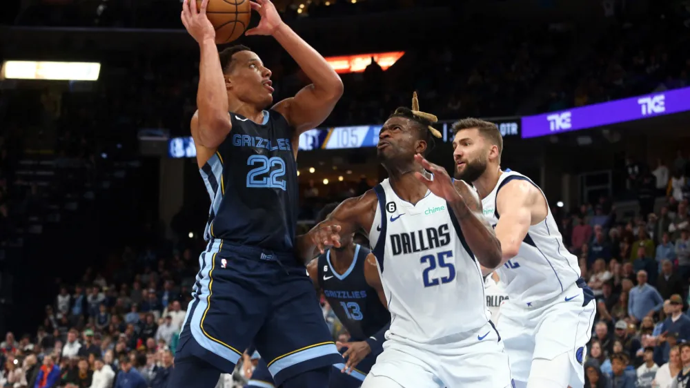 Mar 11, 2023; Memphis, Tennessee, USA; Memphis Grizzlies guard Desmond Bane (22) drives to the basket as Dallas Mavericks forward Reggie Bullock (25) defends during the second half at FedExForum. Mandatory Credit: Petre Thomas-USA TODAY Sports