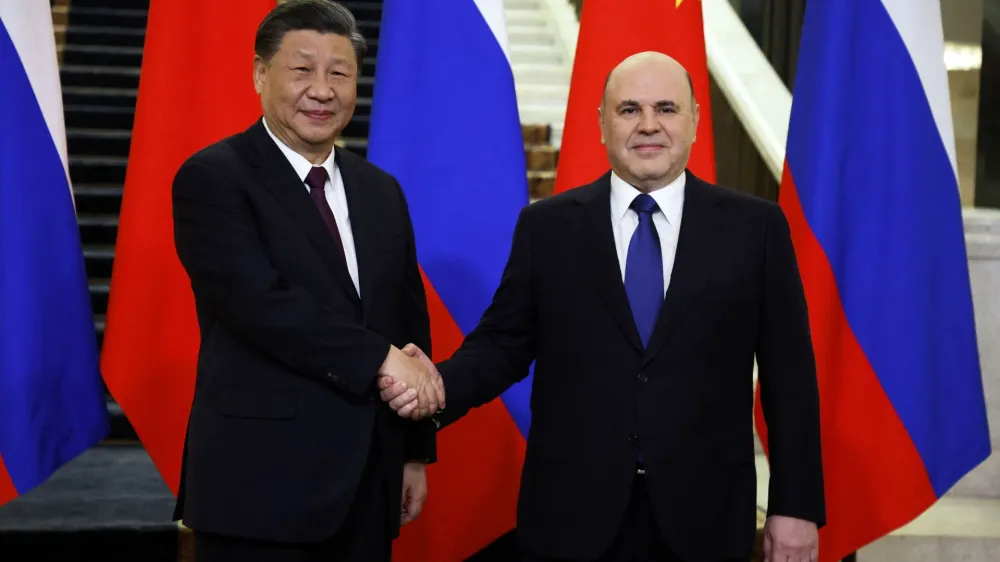 Russian Prime Minister Mikhail Mishustin shakes hands with Chinese President Xi Jinping during a meeting in Moscow, Russia March 21, 2023. Sputnik/Dmitry Astakhov/Pool via REUTERS ATTENTION EDITORS - THIS IMAGE WAS PROVIDED BY A THIRD PARTY.