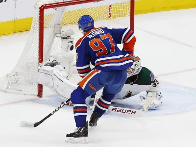 Mar 22, 2023; Edmonton, Alberta, CAN; Edmonton Oilers forward Connor McDavid (97) scores the overtime winning goal, his 60th goal of the season against Arizona Coyotes goaltender Connor Ingram (39) at Rogers Place. Mandatory Credit: Perry Nelson-USA TODAY Sports