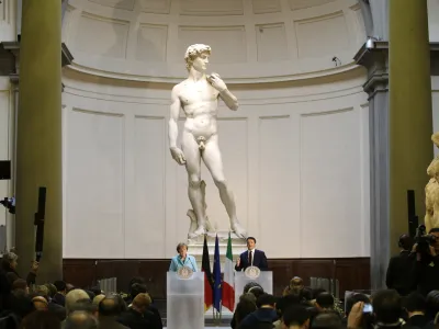 FILE - German Chancellor Angela Merkel, left, and Italian Prime Minister Matteo Renzi speak during a press conference in front of Michelangelo's "David statue" after their bilateral summit in Florence, Italy, on Jan. 23, 2015. The head of Florence's Galleria del'Accademia on Sunday March 26, 2023 invited the parents and students of a Florida charter school to visit and see Michelangelo's "David," after the school principal was forced to resign following parental complaints that an image of the nude Renaissance masterpiece was shown to a sixth-grade art class. (AP Photo/Antonio Calanni, File)