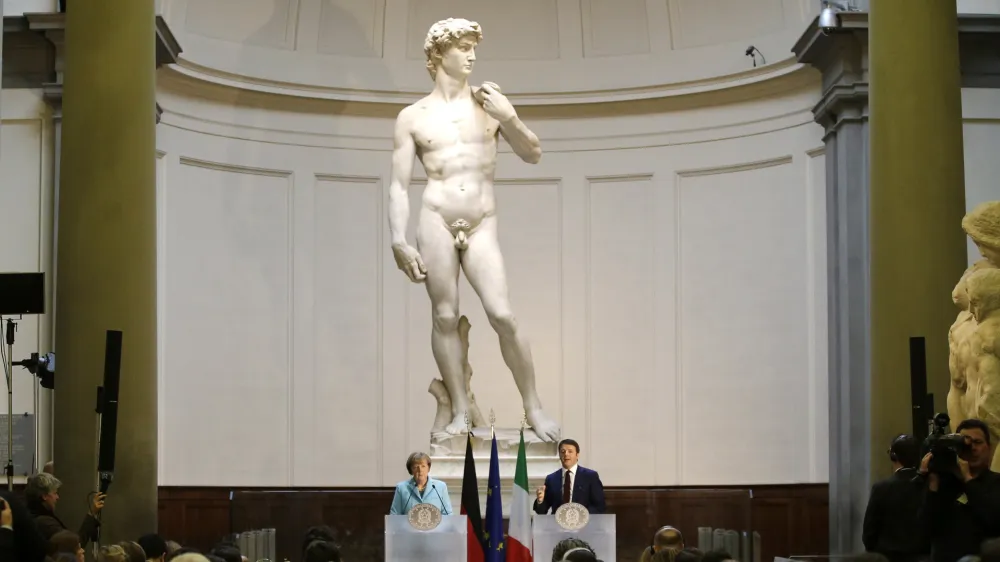 FILE - German Chancellor Angela Merkel, left, and Italian Prime Minister Matteo Renzi speak during a press conference in front of Michelangelo's "David statue" after their bilateral summit in Florence, Italy, on Jan. 23, 2015. The head of Florence's Galleria del'Accademia on Sunday March 26, 2023 invited the parents and students of a Florida charter school to visit and see Michelangelo's "David," after the school principal was forced to resign following parental complaints that an image of the nude Renaissance masterpiece was shown to a sixth-grade art class. (AP Photo/Antonio Calanni, File)