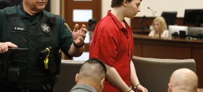 Aiden Fucci is led into the courtroom start his sentencing hearing, Friday, March 24, 2023. in St. Augustine, Fla. A Florida judge sentenced the 16-year-old Florida boy to life in prison on Friday for fatally stabbing a 13-year-old classmate on Mother's Day in 2021. Fucci, who pleaded guilty just before his trial was set to start in February, was not eligible for the death penalty. (Bob Self/The Florida Times-Union via AP)