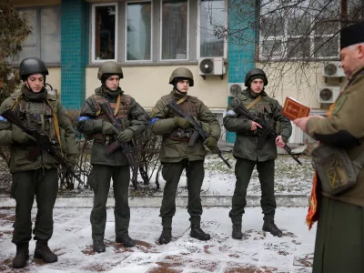 Military Chaplain Nikolay Medynsky reads a prayer before blessing Ukrainian servicemen and their weapons before they go into battle, as Russia's attack on the Ukraine continues, in Kyiv, Ukraine, March 13, 2022. REUTERS/Thomas Peter
