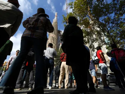People stand outside the Sagrada Familia cathedral in Barcelona, Spain, October 11, 2017. REUTERS/Ivan Alvarado - RC1424C53A60