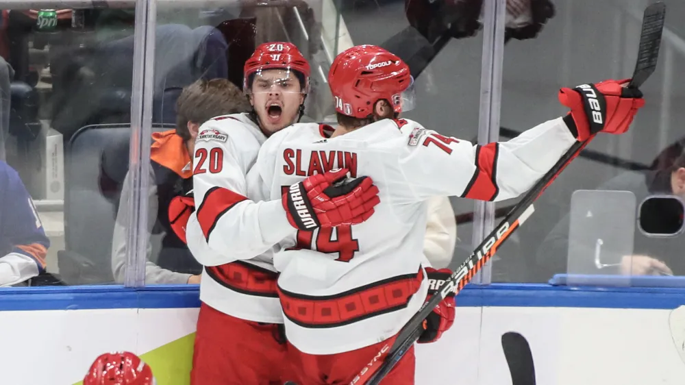 Apr 28, 2023; Elmont, New York, USA; Carolina Hurricanes center Sebastian Aho (20) celebrates with defenseman Jaccob Slavin (74) after scoring a game tying goal in the third period in game six of the first round of the 2023 Stanley Cup Playoffs against the New York Islanders at UBS Arena. Mandatory Credit: Wendell Cruz-USA TODAY Sports