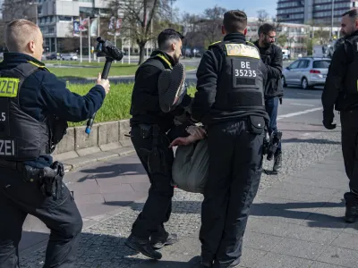 28 April 2023, Berlin: Police officers carry an activist of the Last Generation for Climate Protection off the street at Ernst-Reuter-Platz. Photo: Paul Zinken/dpa