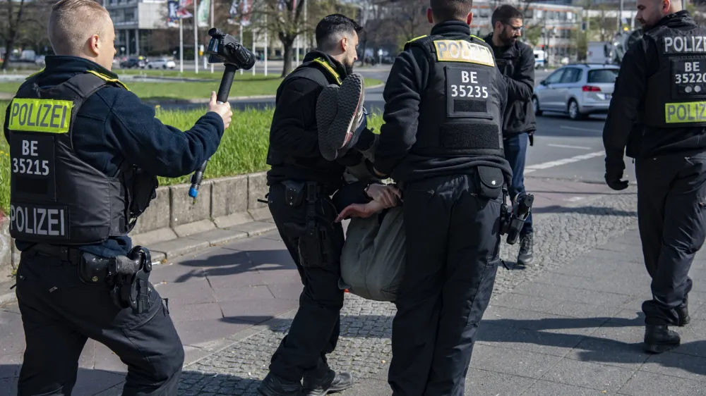 28 April 2023, Berlin: Police officers carry an activist of the Last Generation for Climate Protection off the street at Ernst-Reuter-Platz. Photo: Paul Zinken/dpa