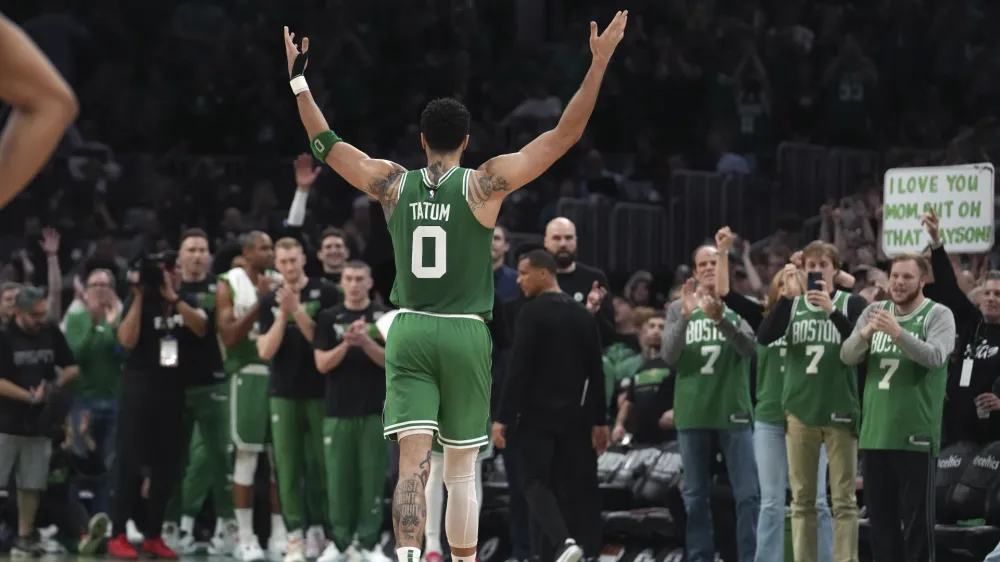 Boston Celtics forward Jayson Tatum (0) receives applause as he steps off the court near the end of Game 7 against the Philadelphia 76ers in the NBA basketball Eastern Conference semifinal playoff series, Sunday, May 14, 2023, in Boston. (AP Photo/Steven Senne)