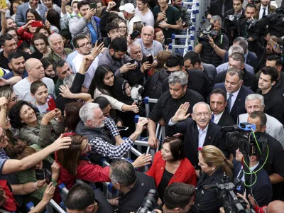 Turkish CHP party leader and Nation Alliance's presidential candidate Kemal Kilicdaroglu, right, waves to supporters after he casted his ballot at a polling station in Ankara, Turkey, Sunday, May 28, 2023. Voters in Turkey returned to the polls Sunday to decide whether the country's longtime leader, Erdogan, stretches his increasingly authoritarian rule into a third decade or is unseated by a challenger who has promised to restore a more democratic society. (Ugur Yildirim/Dia Images via AP)